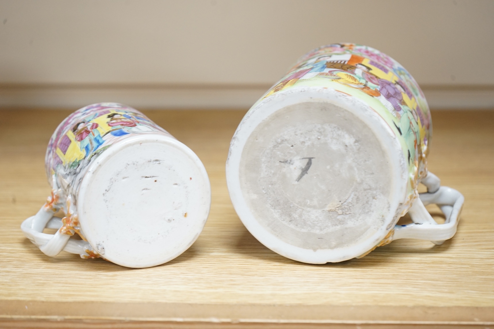 A Chinese Export Canton Famille rose mug and another smaller, Daoguang period (1821-50), tallest 12cm